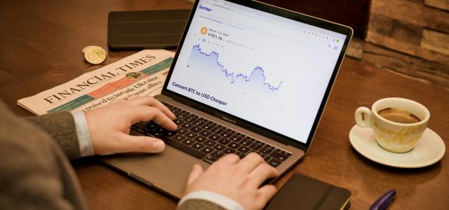 a person typing on a laptop on a table by Sortter courtesy of Unsplash.